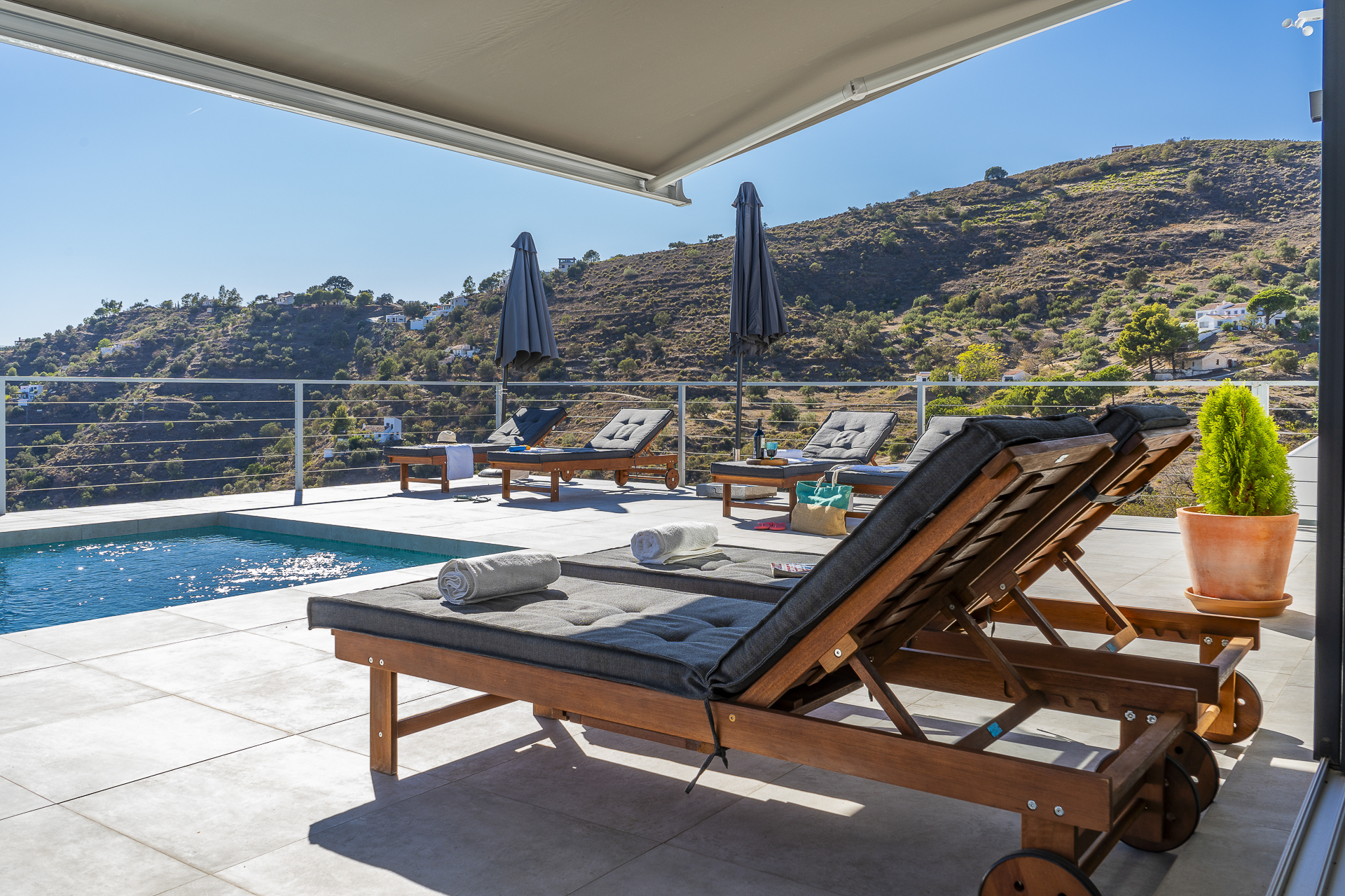 Terrace with awning, sun loungers and pool